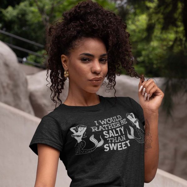 stylish woman with a shirt that says I would rather be salty than sweet between two mermaids